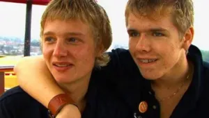 Een foto van twee jongens. De ene jongen heeft zijn arm over de schouder van de andere jongen.