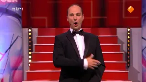 Foto van de presentator van Snugger die staat in de studio, hij zingt.