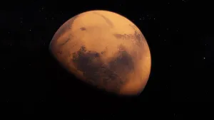 Foto van Mars in de ruimte, je ziet bijna de hele planeet.