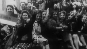 Oude zwart/wit foto van veel mensen in feeststemming ten tijde van Dolle Dinsdag, Tweede Wereldoorlog.