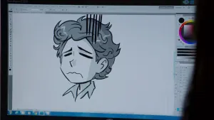 Foto van een beeldscherm waarop een tekening staat van het gezicht van een man/jongetje, het is een tekenprogramma.