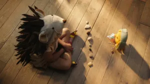 Foto van een kind verkleed als egel die op de grond zit met dropje (stoffen pop) die erbij staat, op de grond ligt een rijtje stenen.