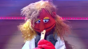 Foto van scène uit de Boterhamshow met portret van Jamie (pop) die blokfluit speelt.