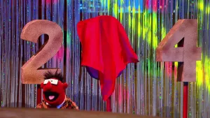 Foto van scène uit de Boterhamshow met Pi R Kwadraat aan tafel en een twee, afgedekte drie, vier.