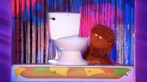 Foto van scène uit Boterhamshow met pop, Henk de Bruin, bij een toiletpot.