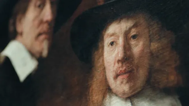 Een foto van een schilderij van Rembrandt waarop twee gezichten te zien zijn.