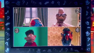 Een foto van een beeldscherm met vier beelden van poppen: pop één draagt een rode bloem in haar haren, pop twee draagt een witte blouse met rode stropdas en een bril, pop drie draagt een rode trui en pop vier met een zwart en witte baard heeft een bril.