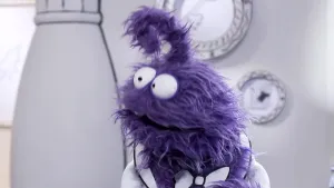 Een foto van een paarse pop die in het 'Het Museum van Gewone Dingen' staat.