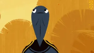 Een beeld uit de animatieserie over spin Anansi. Op het beeld is de kop en een deel van de voorkant van het schild van een zwart-grijze schildpad te zien. De achtergrond heeft verschillende kleuren geel, waar vormen van bladeren in te herkennen zijn. 