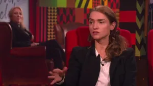 Een foto van een vrouw die in de studio zit van Eus' Boekenclub. Op de achtergrond zit er een vrouw van het publiek.