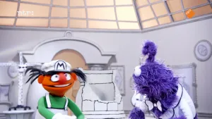 Een foto van een oranje pop die met een paarse pop praat.