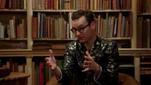 Foto van Splinter Chabot in zwart met goud jasje in oude bibliotheek.