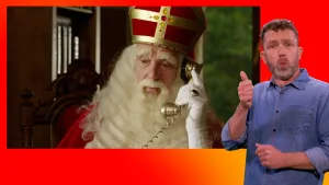 Sinterklaas is aan het bellen. De gebarentolk staat naast het scherm.