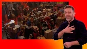 Sinterklaas, de Pieten en Merel vieren feest in het Pakjesruim. Naast het scherm staat de gebarentolk.