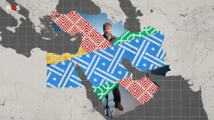 Een samengestelde afbeelding. Een kaart van het Midden-Oosten, willekeurig ingekleurd met verschillende patronen. Sommige delen zijn niet ingevuld, daar is presentator Emil in de studio doorheen te zien.