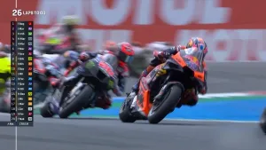Foto van motorrijders op het asfalt van TT Circuir Assen, ze hangen schuin naar rechts in de bocht.
